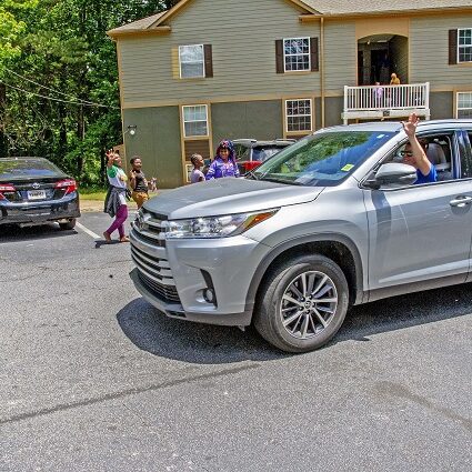 Faculty from the Global Village Project, a school for young refugee women in Decatur, held a car parade through their students’ neighborhoods to celebrate their graduation May 16. Photo by Dean Hesse.